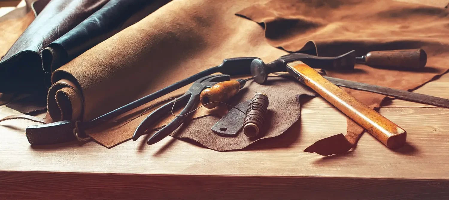 Collection of leather working tools and materials for genuine leather projects.
