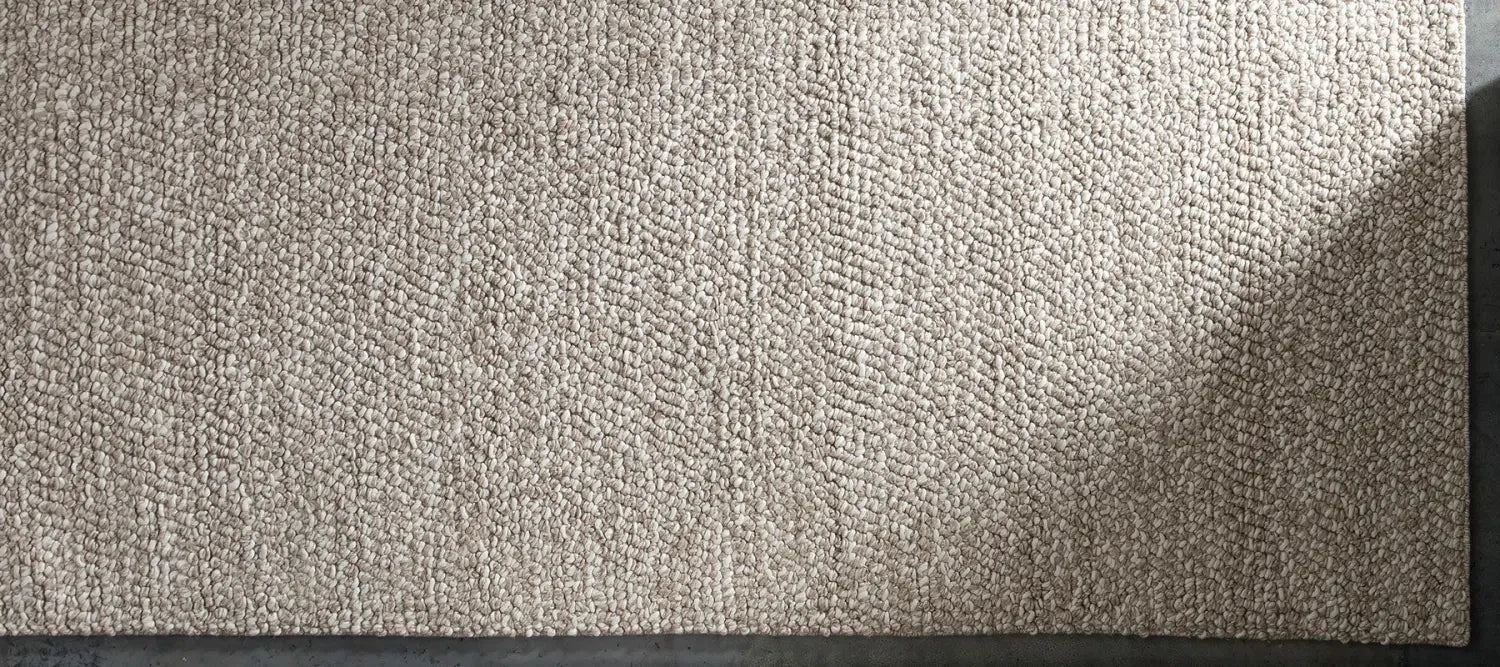 Beige rug texture with shadow highlighting home decorating benefits for outdoor areas.