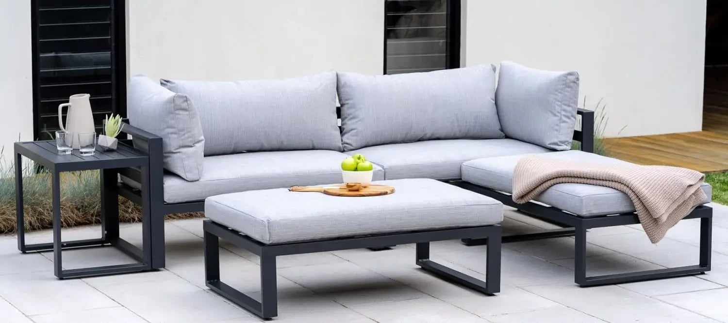 Modern outdoor sectional sofa set with light gray cushions and black metal frames in Aluminium Furniture.