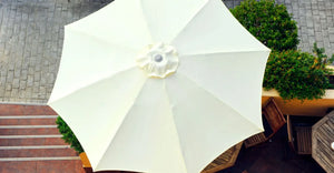 White umbrella seen from above on the terrace of a beach bar