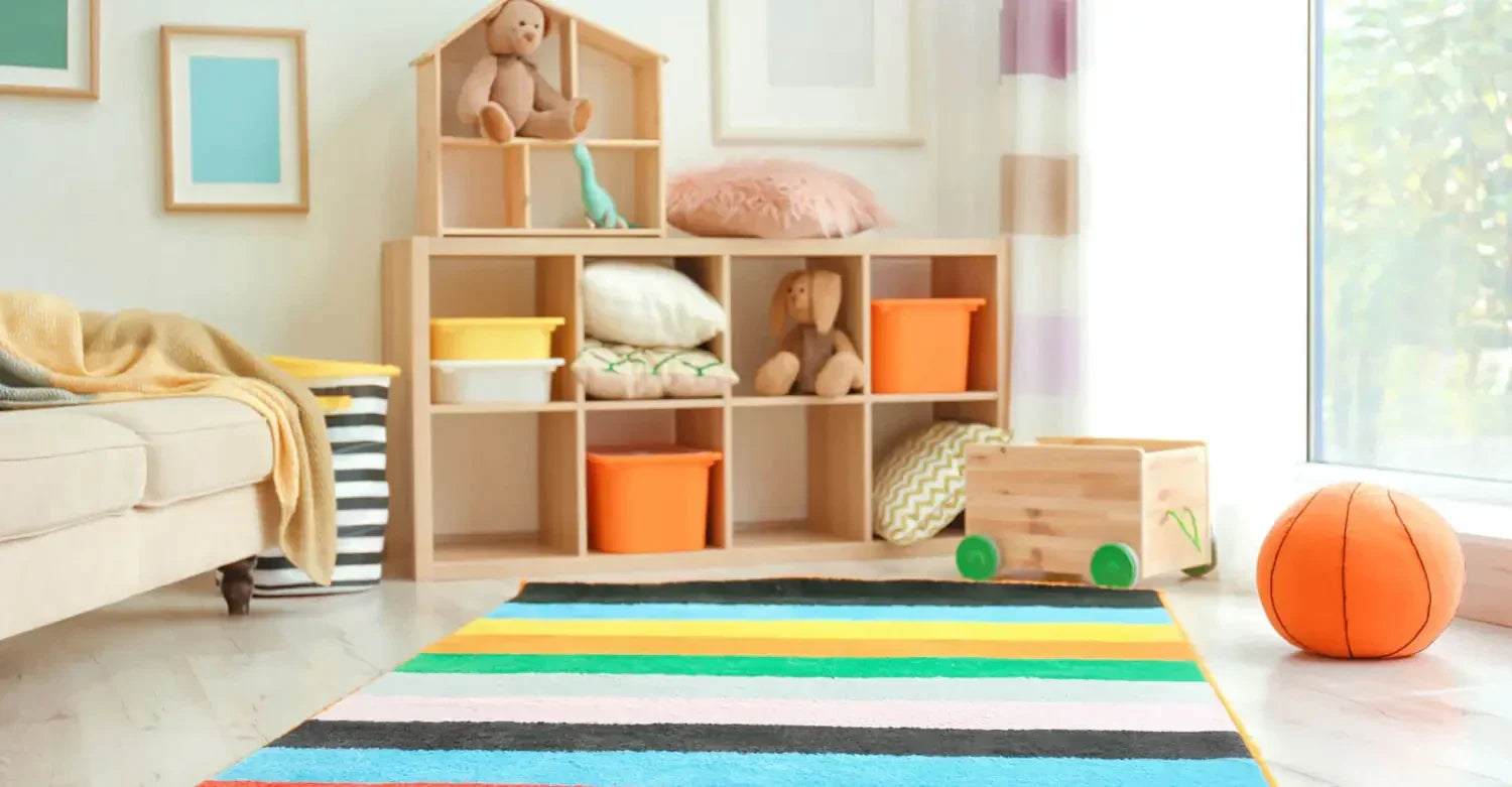 Wooden shelving unit with toys and storage for a stylish child’s room with Bayliss rugs.