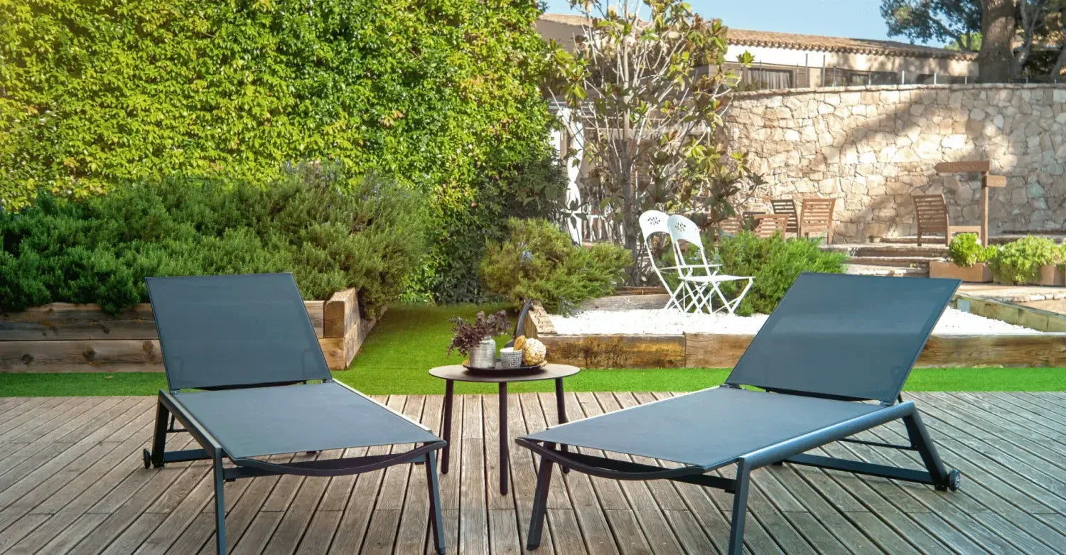 Two blue lounge chairs on a wooden deck complement an outdoor sofa set for relaxation.