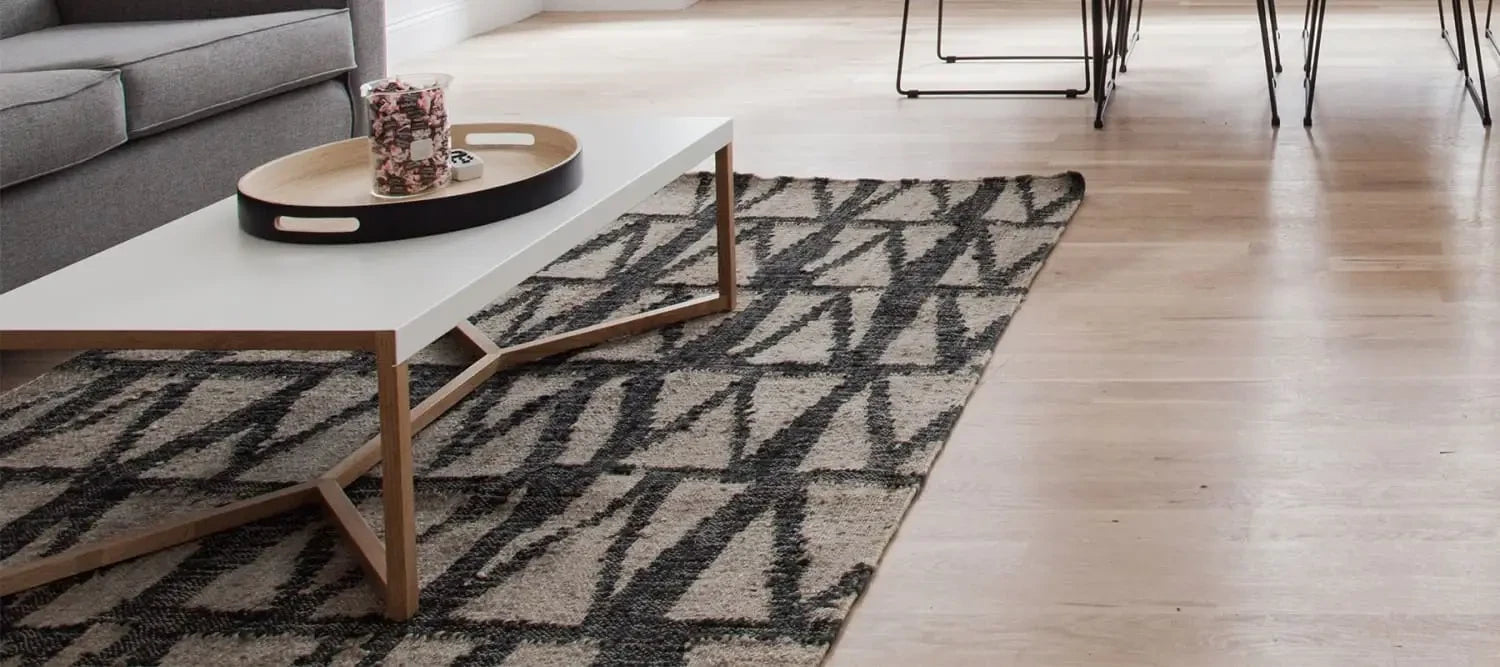 Geometric patterned floor rug featuring a dark and light contrasting design.