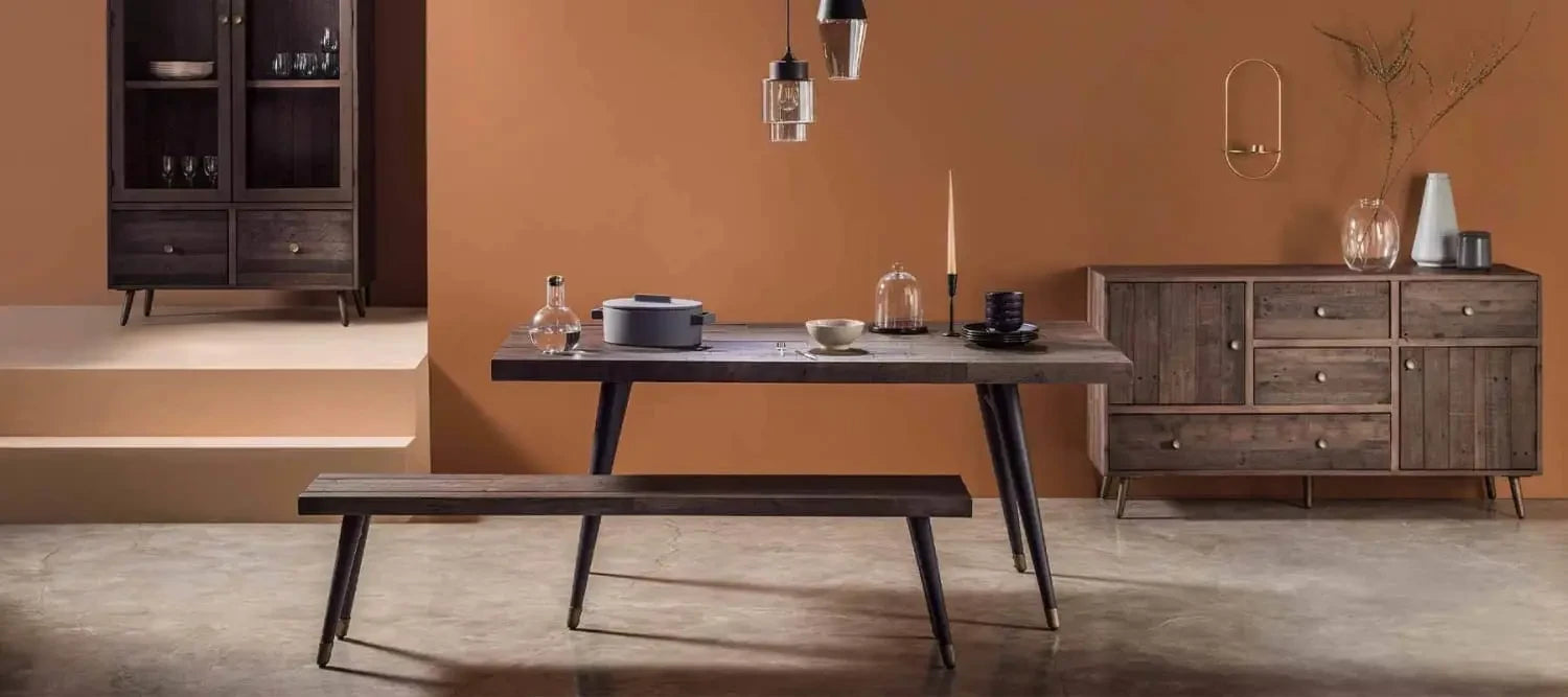 Mid-century modern reclaimed wood dining table and bench in dark finish for eco-friendly homes.