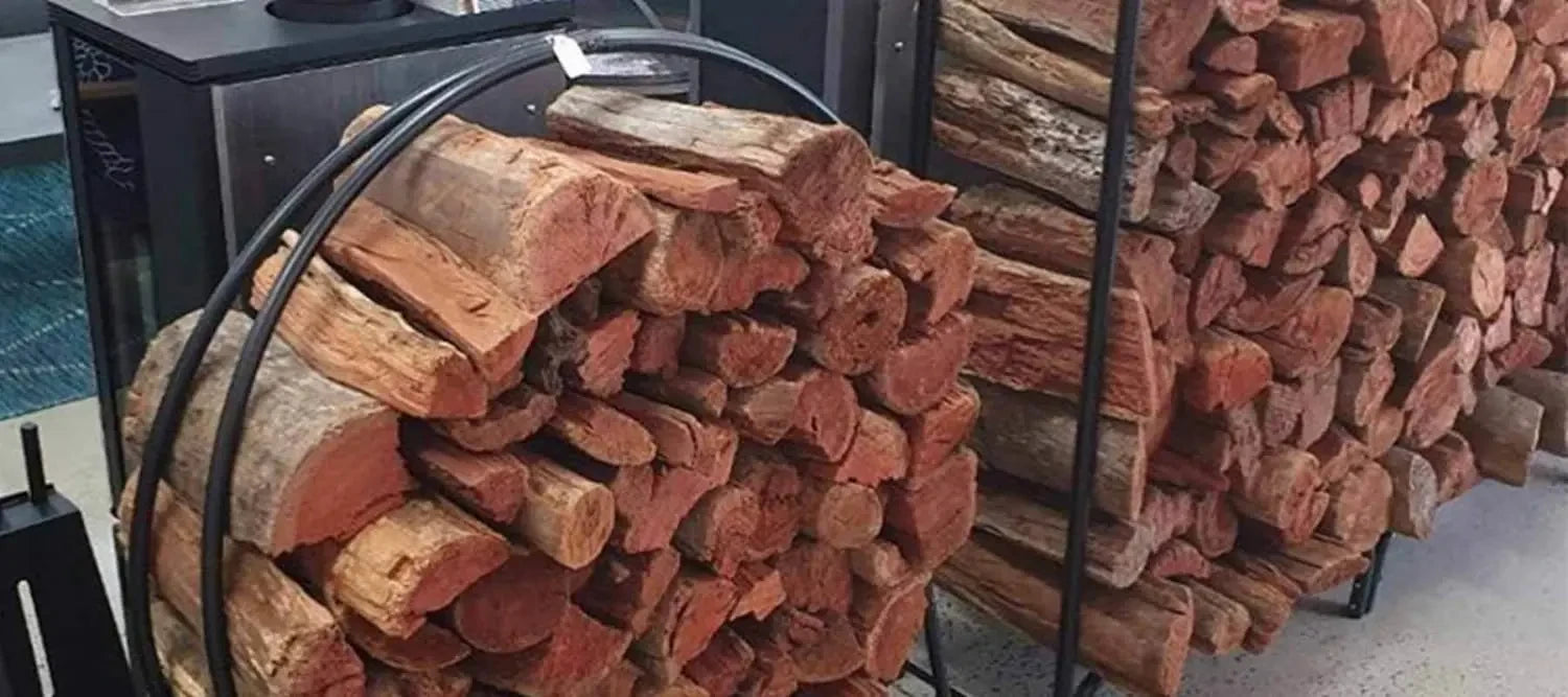 Stack of chopped firewood logs in a metal rack for efficient wood heater burns.