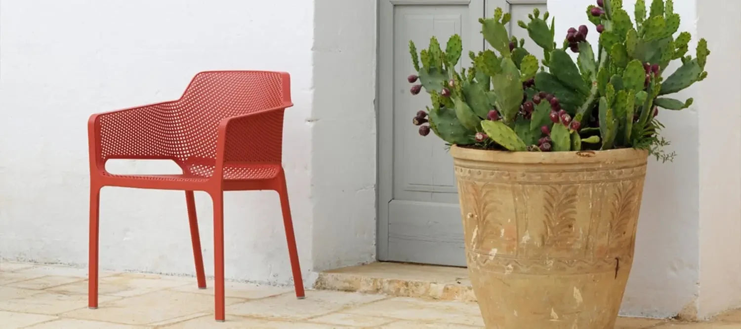 Red net chair with perforated design, inspired by Living Coral, Pantone Colour of the Year.