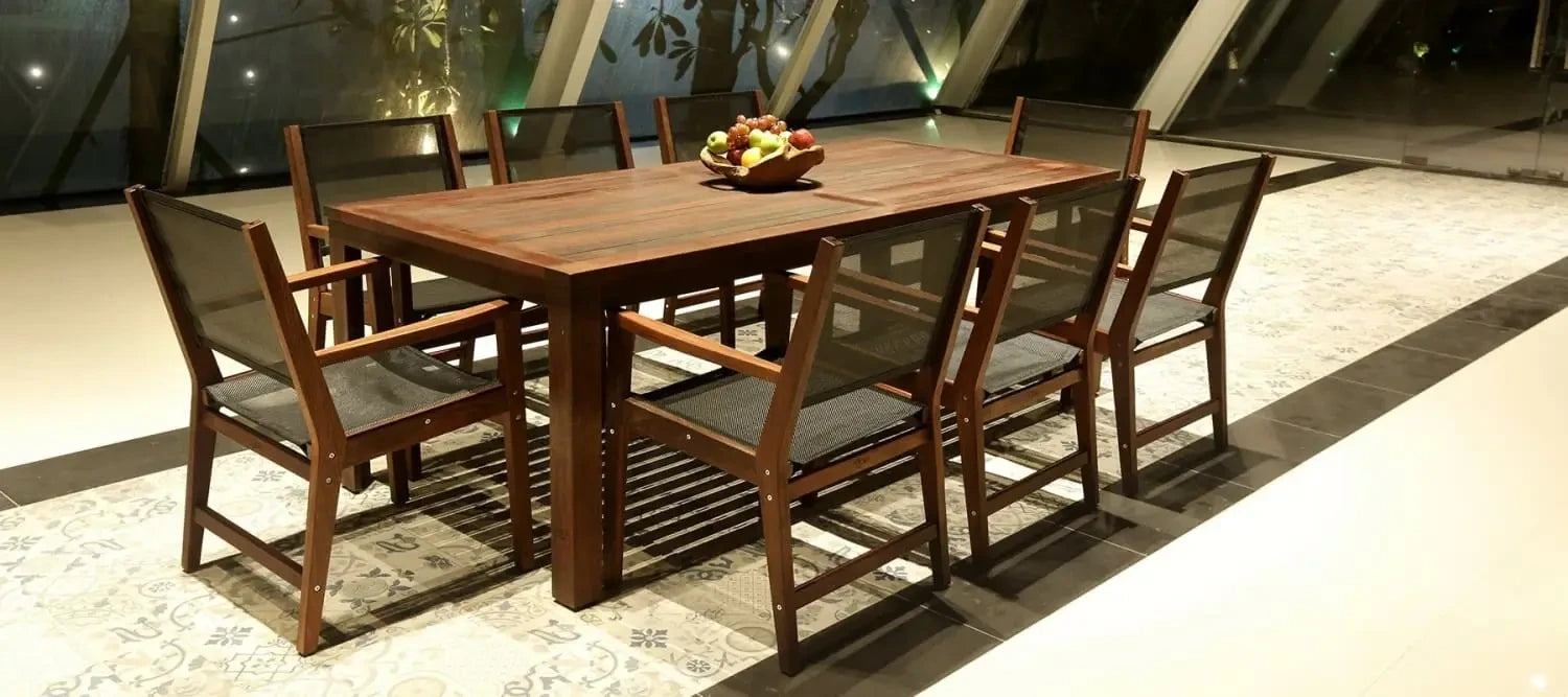 Merbau Timber dining table with matching chairs and fruit bowl, showcasing its silver grey colour.
