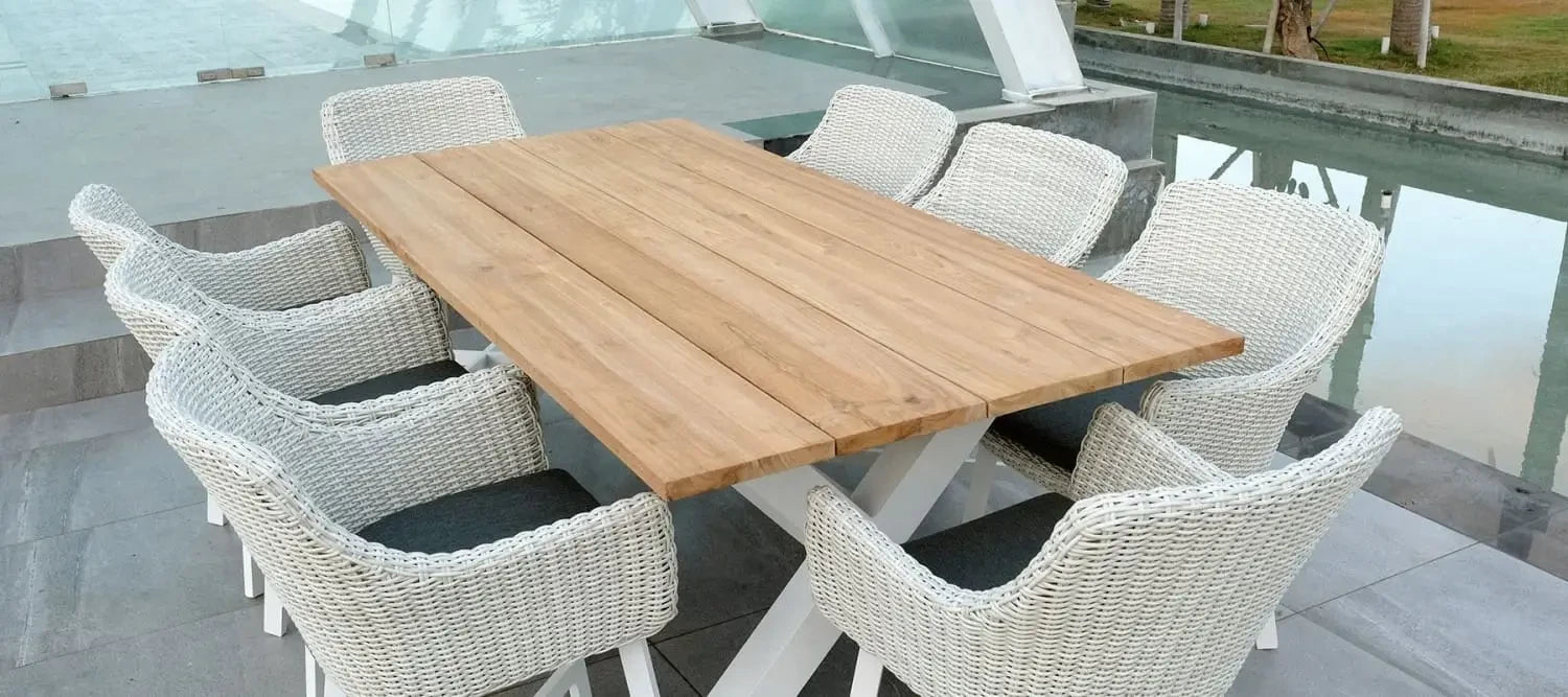 Outdoor dining set featuring a wooden table and woven wicker chairs for stylish spaces.