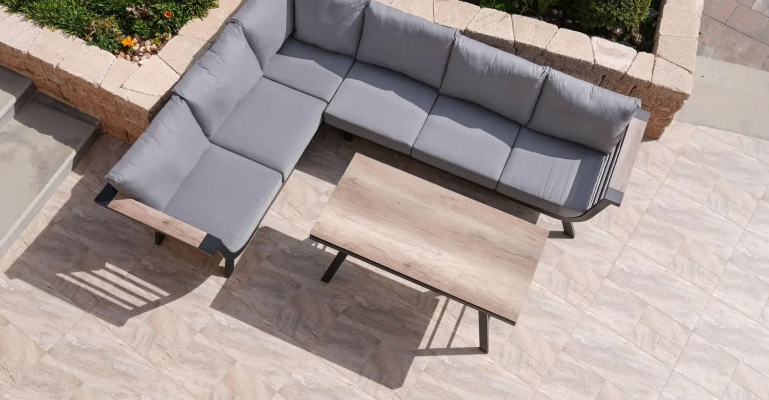 L-shaped outdoor sectional sofa with gray cushions and coffee table from Nardi outdoor furniture