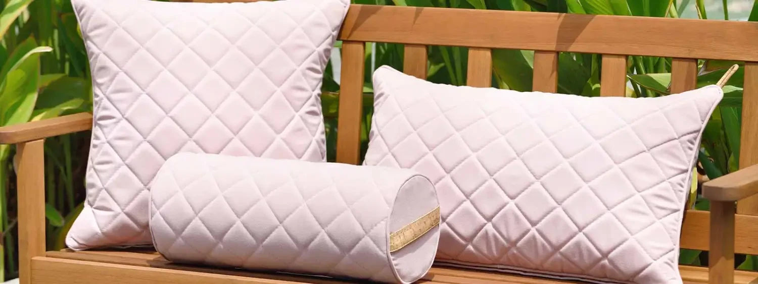 White quilted decorative pillows with a diamond pattern for outdoor cushions collection.