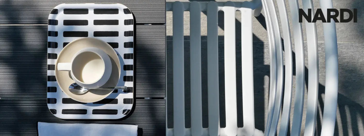 Striped black and white tray with coffee cup on Nardi outdoor furniture in stylish setting