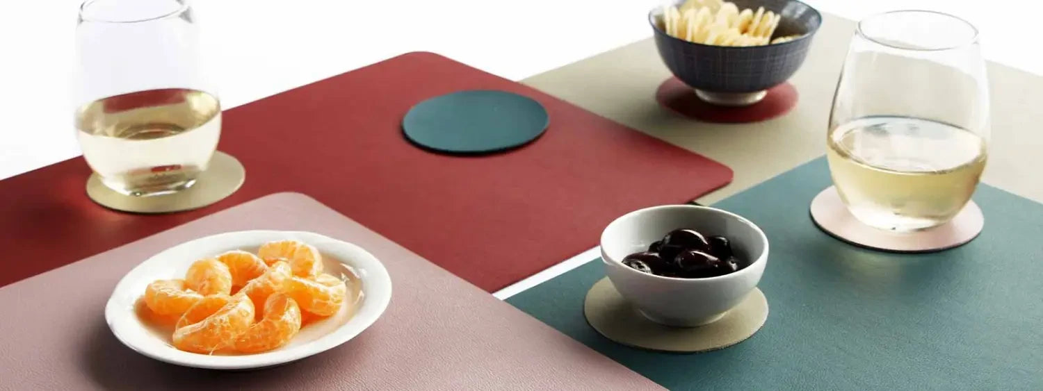 Colorful geometric table with round woven cotton placemat and dishes on display